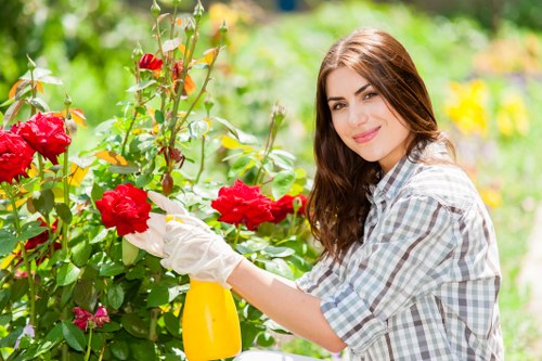 Free quote sign with gardener assessing a suburban garden