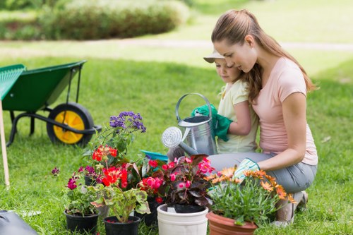 Worker using powered garden equipment with protective gear