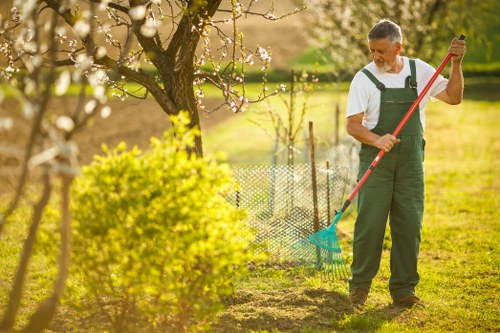 Volunteer working with plants at a Northolt community plot